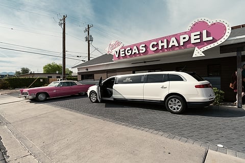 A limousine in front of a wedding chapel sign in Las Vegas, Nevada